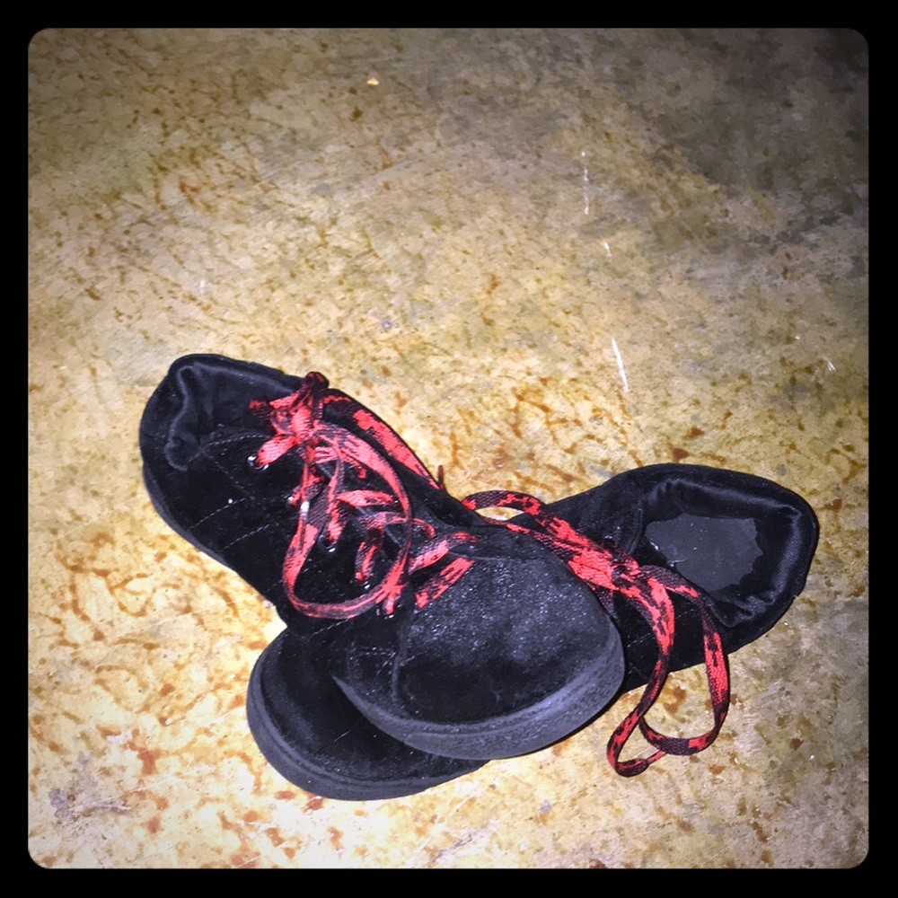 Red and back laced black velvet shoes